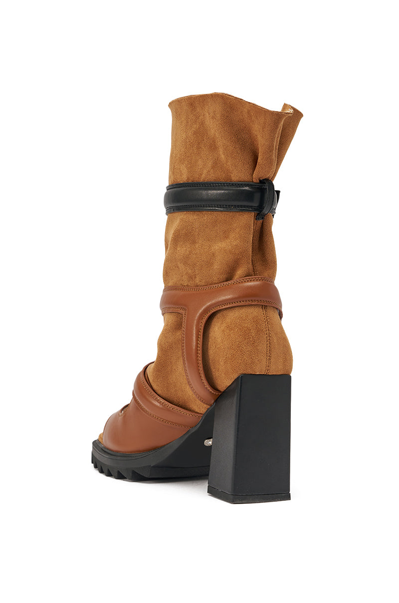 The AZALEA WANG THIERRY TAN FAUX SUEDE OPEN TOE CHUNKY BOOTIE features a mid-calf brown faux suede design, leather accents, a chunky black heel, black strap detail at the upper, and a ridged black sole. Shown against a white background. 4