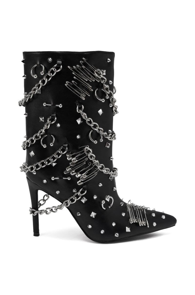 The AZALEA WANG THRIGRUN BLACK SILVER HARDWARE STILETTO BOOTIE is a black faux leather bootie with a pointed toe, silver studs, safety pins, hoops, and multiple silver chains for bold punk-inspired style.