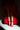 In dramatic lighting, someone wears a voluminous red ruffled gown and AZALEA WANG THUNDERMINE red velvet embellished stiletto sandals with comfort cushions. The gown's asymmetric hem showcases their legs while holding a black studded clutch.