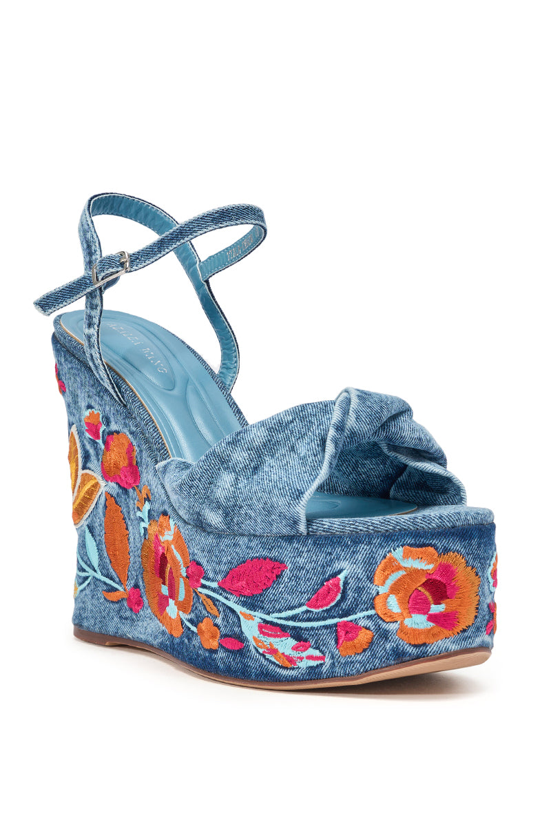 The AZALEA WANG TIALA DENIM FLORAL EMBROIDERED STRAP WEDGE SANDAL features a high denim wedge, ankle strap, and vibrant red, orange, and pink floral embroidery on the platform and sides. 5