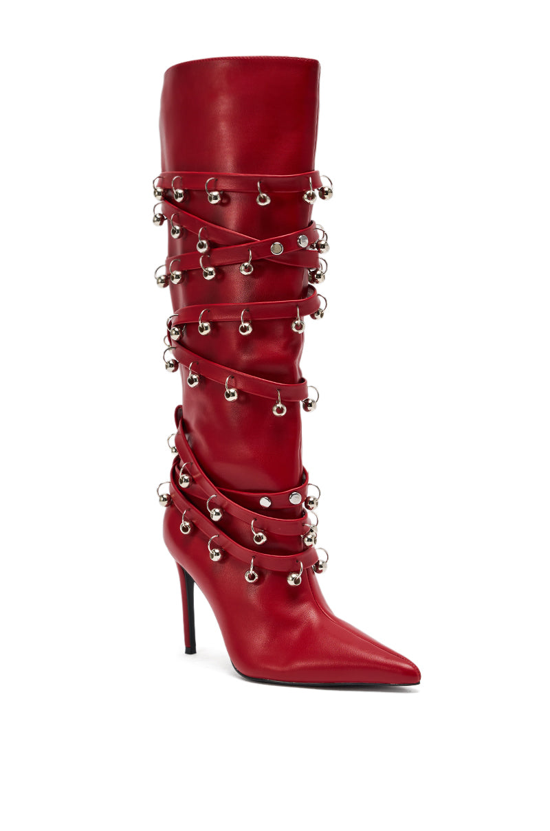 The AZALEA WANG TIMPANI Red Western Fringe Stiletto Boot features a tall, pointed toe silhouette, crafted from faux leather with red fringe and silver stud details wrapped around the shaft.