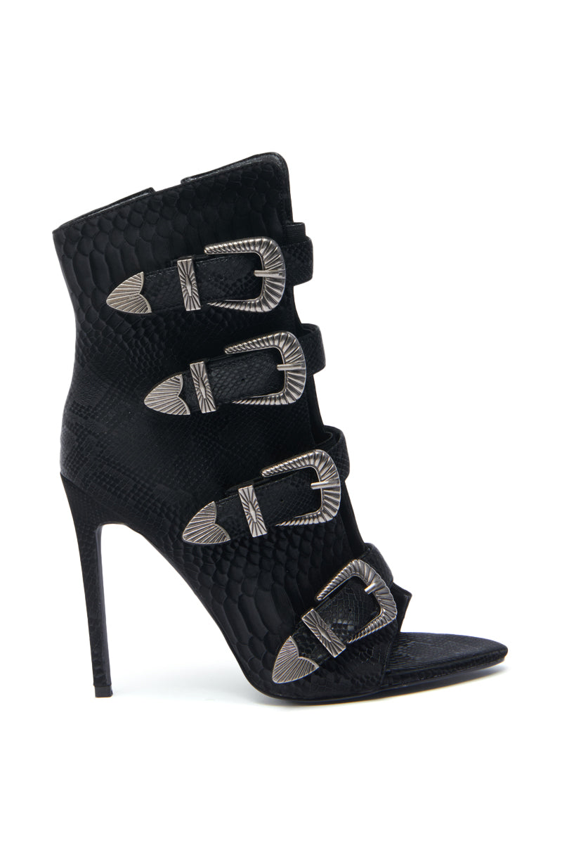 The AZALEA WANG TJEERD BLACK WESTERN BUCKLE OPEN TOE BOOTIE features a stiletto heel, textured black snakeskin print, open toe, and four silver decorative buckles across the front.
