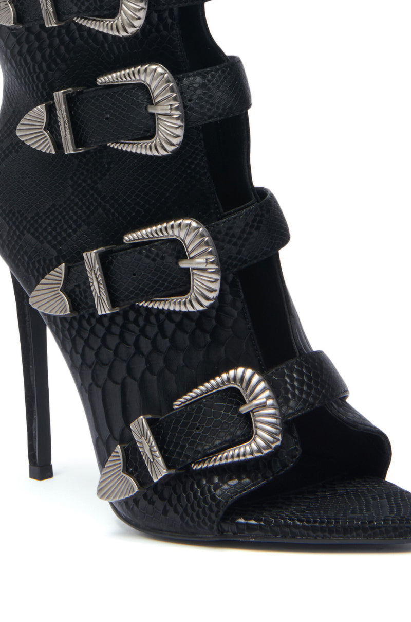A close-up of the AZALEA WANG TJEERD BLACK WESTERN BUCKLE OPEN TOE BOOTIE, showcasing black snakeskin print, multiple silver buckle straps, and an open toe design.