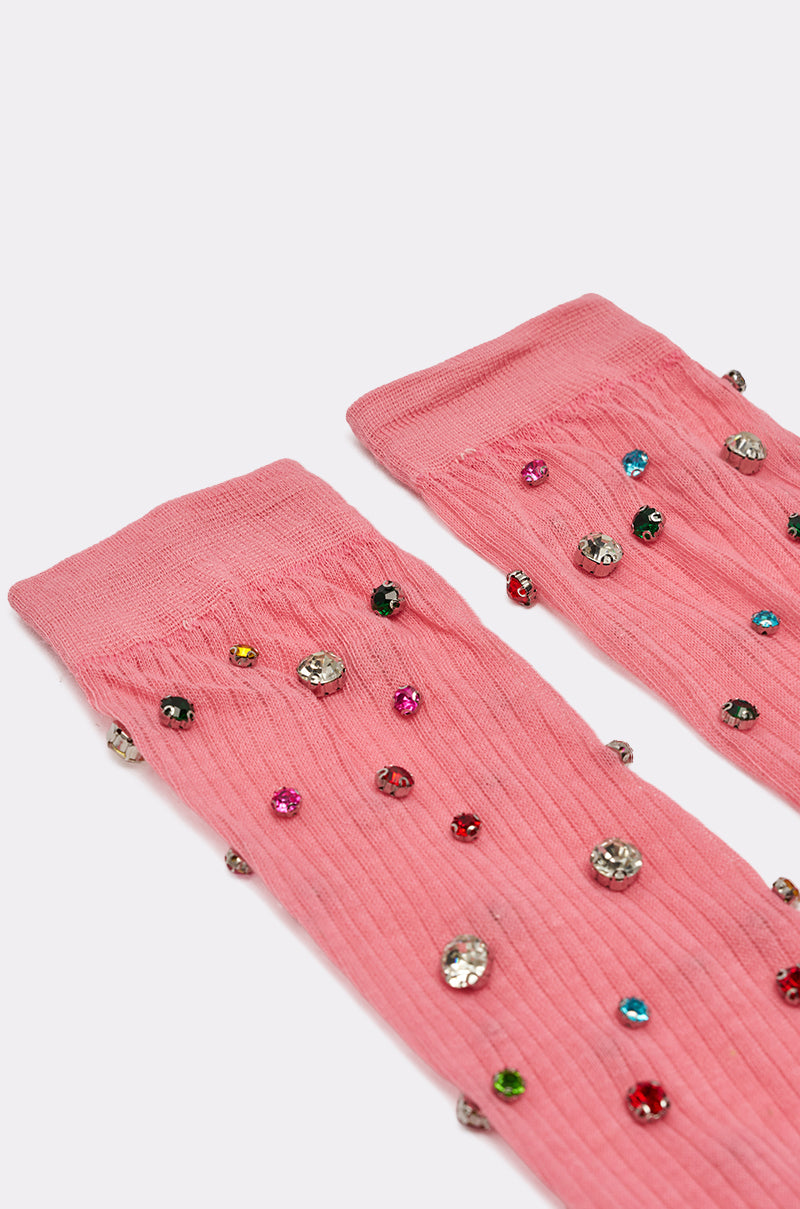 COMPLETE THE LOOK EMBELLISHED SOCKS are pink knee-high socks adorned with colorful, shiny gemstones and beads scattered on ribbed fabric for a dazzling effect. 4