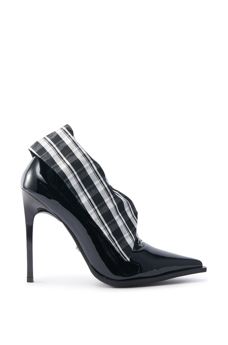 The AZALEA WANG TLALLI BLACK COLLARED PUMP STILETTO is a glossy pointed-toe stiletto with patent faux leather and a unique black and white checkered fabric detail wrapping around the ankle.