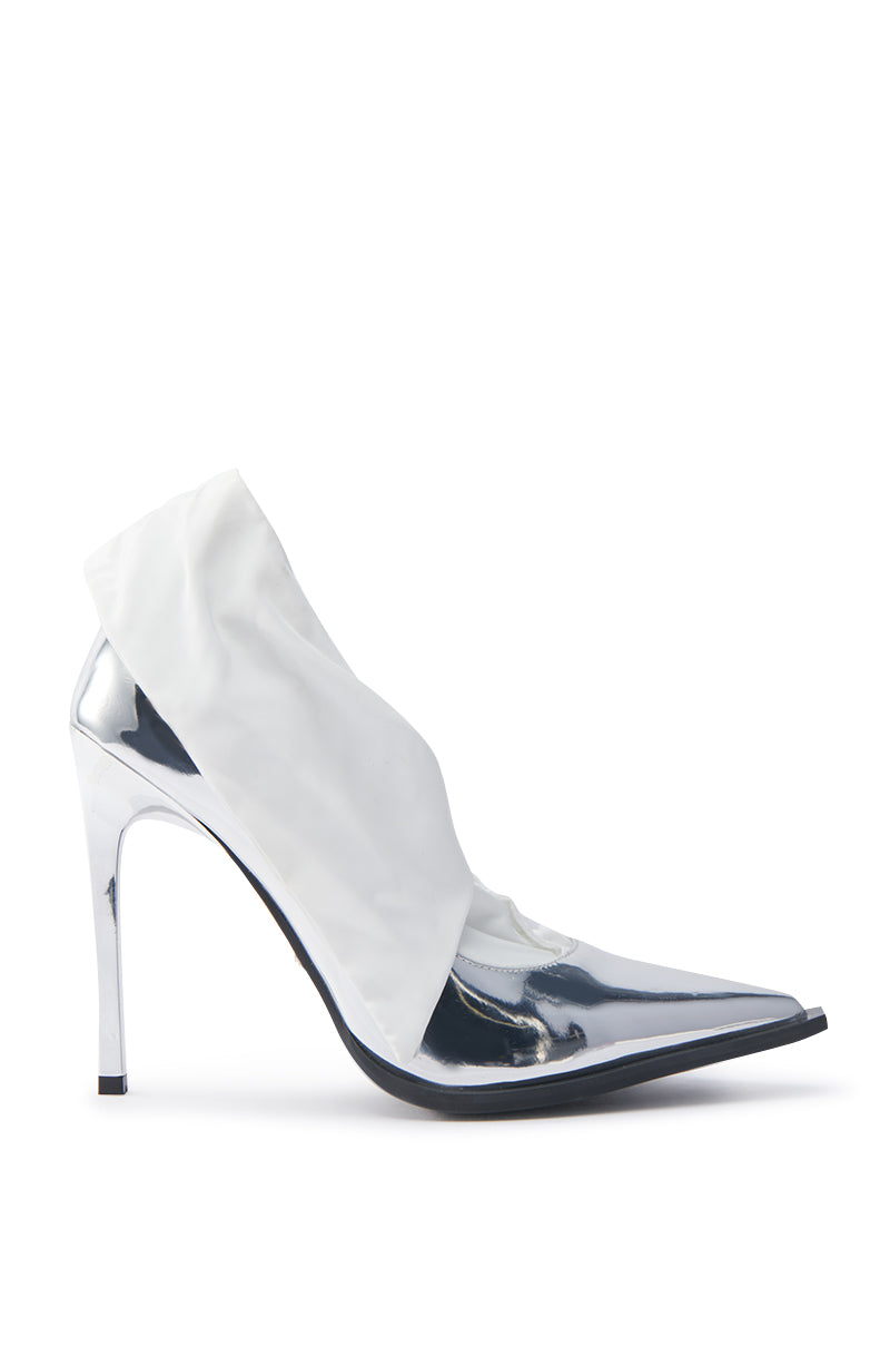 The AZALEA WANG TLALLI SILVER PUMP STILETTO features a high-gloss mirror finish with a metallic pointed toe and heel, complemented by a chic white fabric overlay on the front for a sleek, modern design.