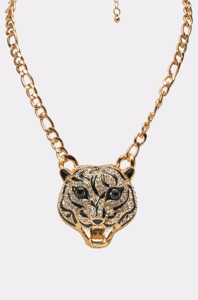The HEAR ME NECKLACE features a gold chain and a detailed tiger head pendant adorned with black and clear rhinestones, open mouth design, and intricate markings—making it a bold statement accessory. 2