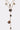 The HERE FOR THE VIBES NECKLACE showcases a gold chain with multiple hammered, irregular round and oval pendants at varying lengths for a layered, textured style. Photographed on a plain white background.