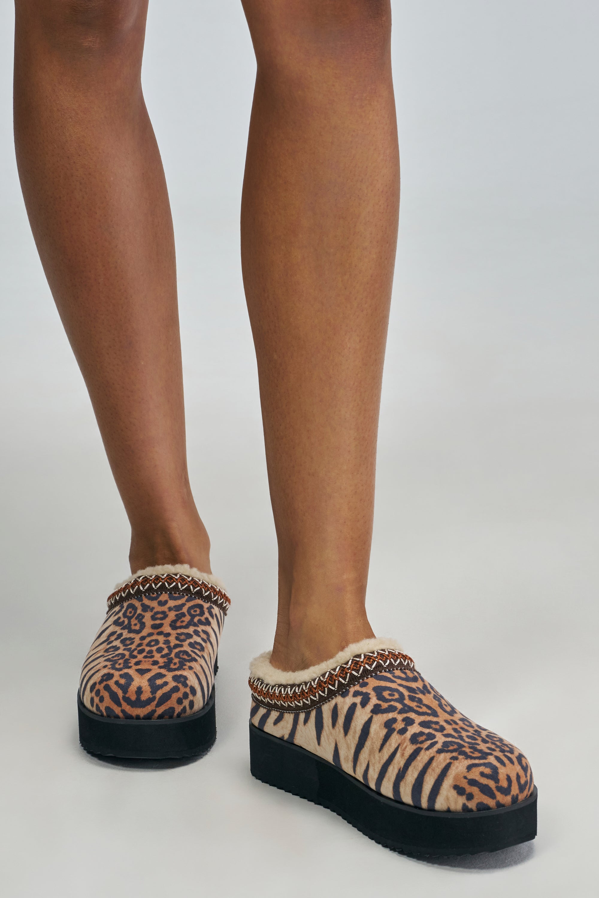 AZALEA WANG TOBY ANIMAL PRINT FLAT leopard-print flatform clogs with a shearling-lined collar and woven trim.