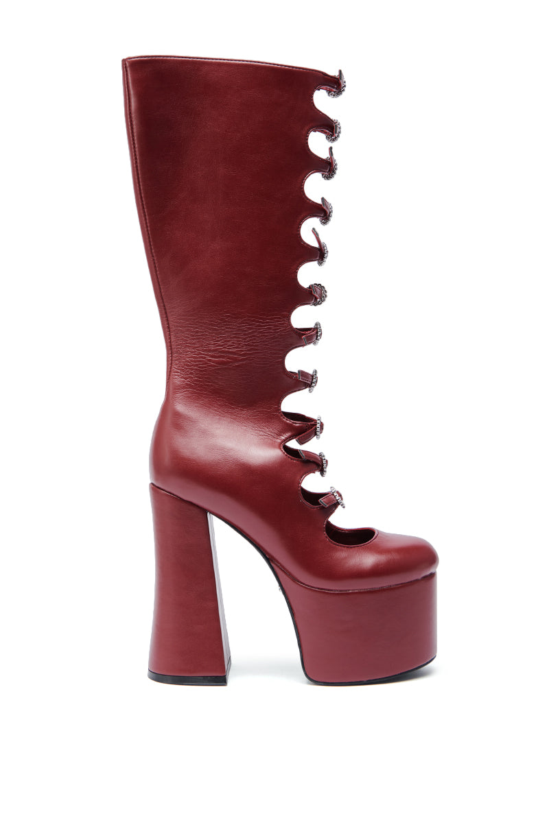 The AZALEA WANG TOMLIN BURGUNDY PLATFORM BOOT features a tall faux leather design with front cut-out lace-up detail and a chunky heel for extra height and style.