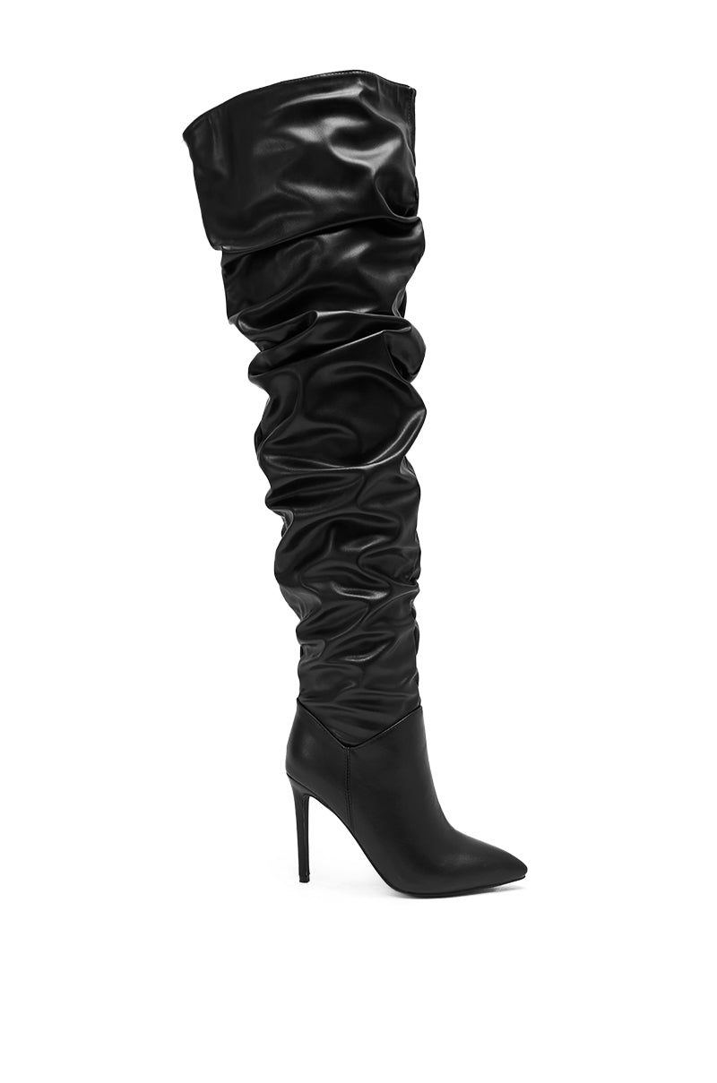 The AZALEA WANG TORVIS Ruched Stiletto Boot in black features a pointed toe, over-the-knee slouchy ruched shaft, and shiny faux leather, displayed against a plain white background.