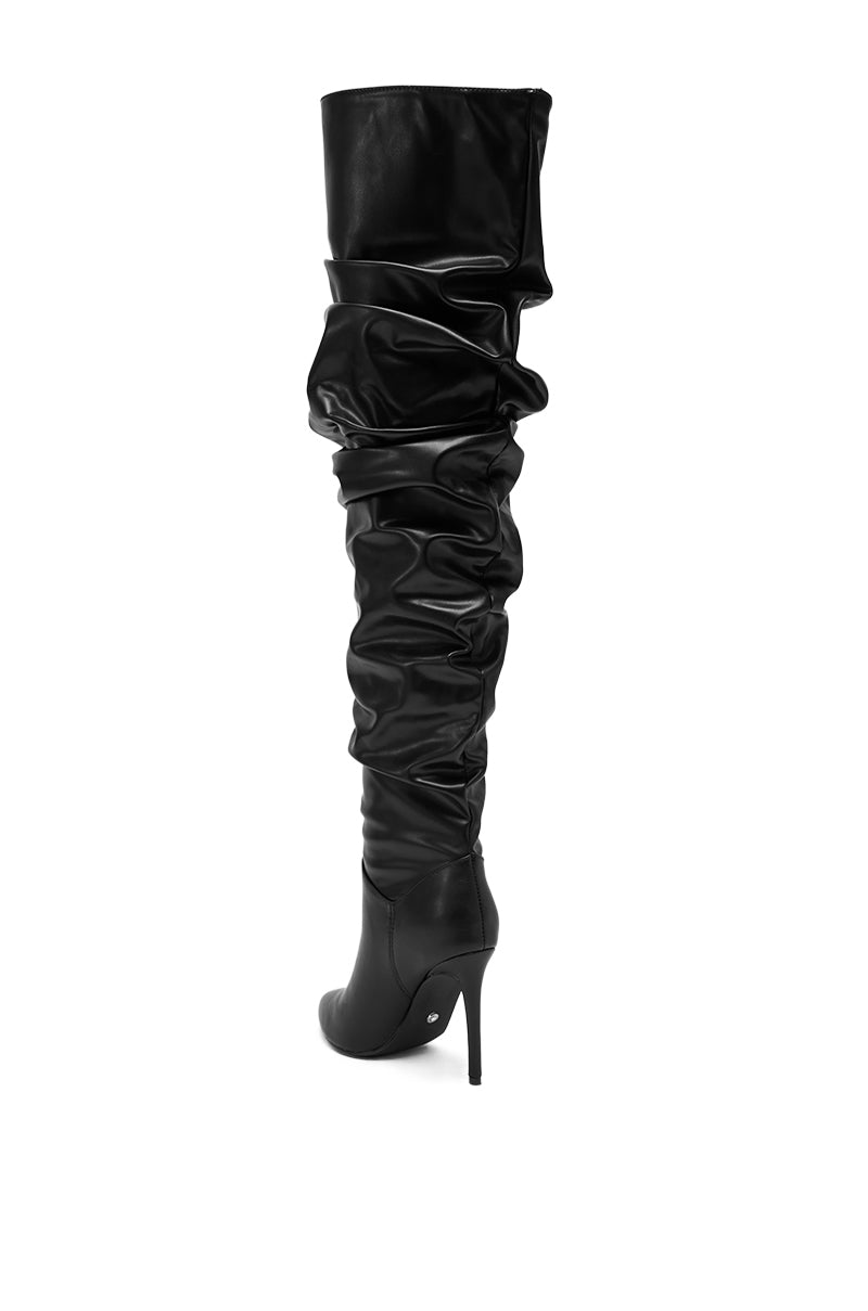 The AZALEA WANG TORVIS RUCHED STILETTO BOOT IN BLACK features a stylish ruched shaft, high stiletto heel, and sleek black faux leather design.