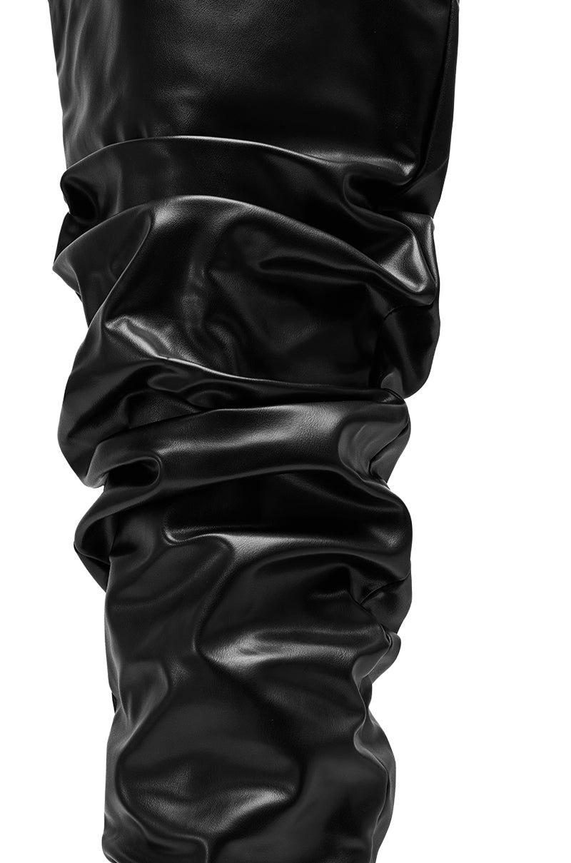 Close-up of the AZALEA WANG TORVIS Ruched Stiletto Boot in black, featuring a shiny ruched shaft with soft folds and creases, reminiscent of faux leather boots, isolated on a white background.