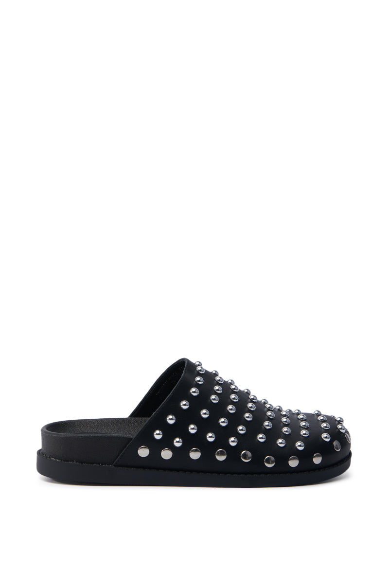 The AZALEA WANG TRAVERSE BLACK CLOG is a black slip-on crafted from faux leather, adorned with silver studs on top. It features a flat, comfort-cushion sole and is presented in a chic side view against a white background.