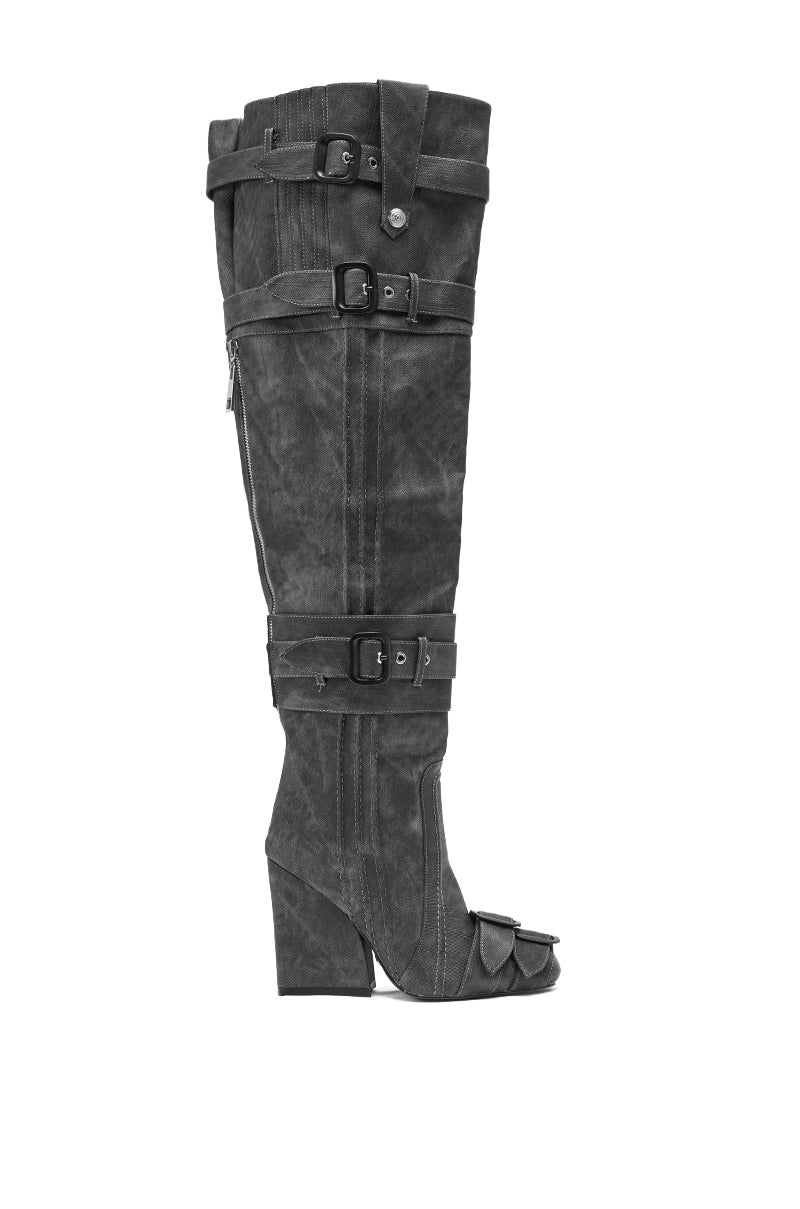 The AZALEA WANG TRILLION CHARCOAL CHUNKY THIGH HIGH BOOT is a tall black suede, distressed boot featuring multiple straps and buckles, an open toe, and a chunky angled heel, displayed in side profile against a white background.