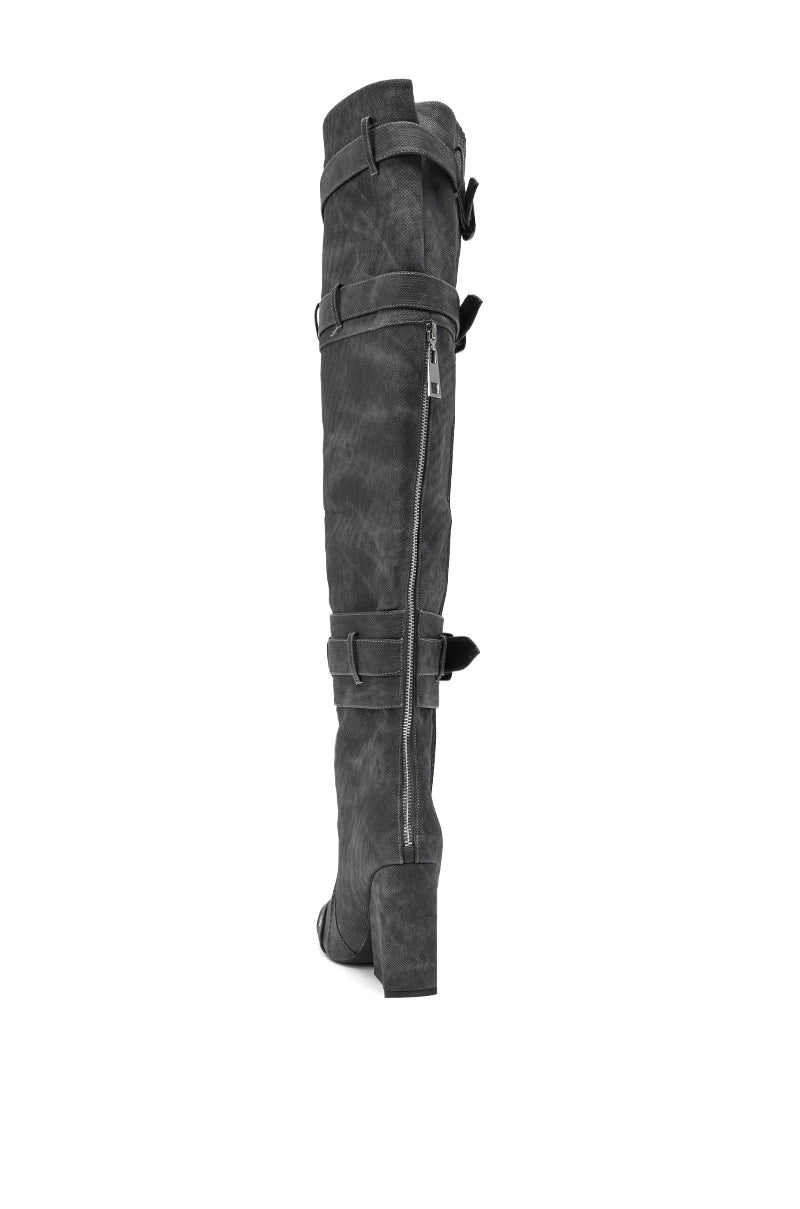 The AZALEA WANG TRILLION Charcoal Chunky Thigh High Boot is shown from a rear side angle against a white background, featuring a tall silhouette, block heel, decorative straps, buckles, and a side zipper.