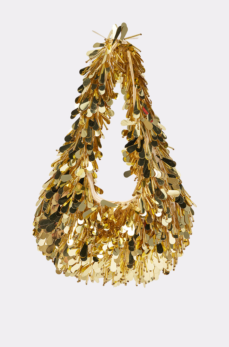THE NOSTALGIA SEQUIN PURSE IN GOLD features reflective, oval-shaped metallic sequins on a shiny gold triangular soft bag with a top handle. Festive and eye-catching, it's the perfect textured statement piece for special occasions.