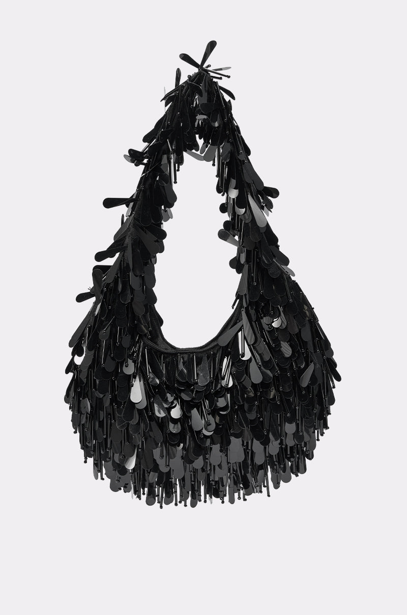 THE NOSTALGIA SEQUIN PURSE IN BLACK features a hobo silhouette with shimmering sequins for a striking, textured look, displayed against a plain light background. 0