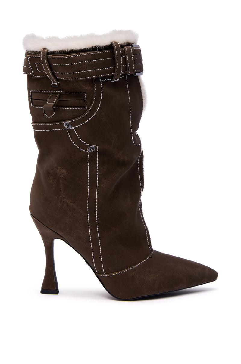 The AZALEA WANG TROYES Brown Sherpa Lined Pant Look Bootie is an ankle-high suede boot featuring white stitching, a pointed toe, flared high heel, decorative belt and buckle at the top, and cozy sherpa lining at the cuff.