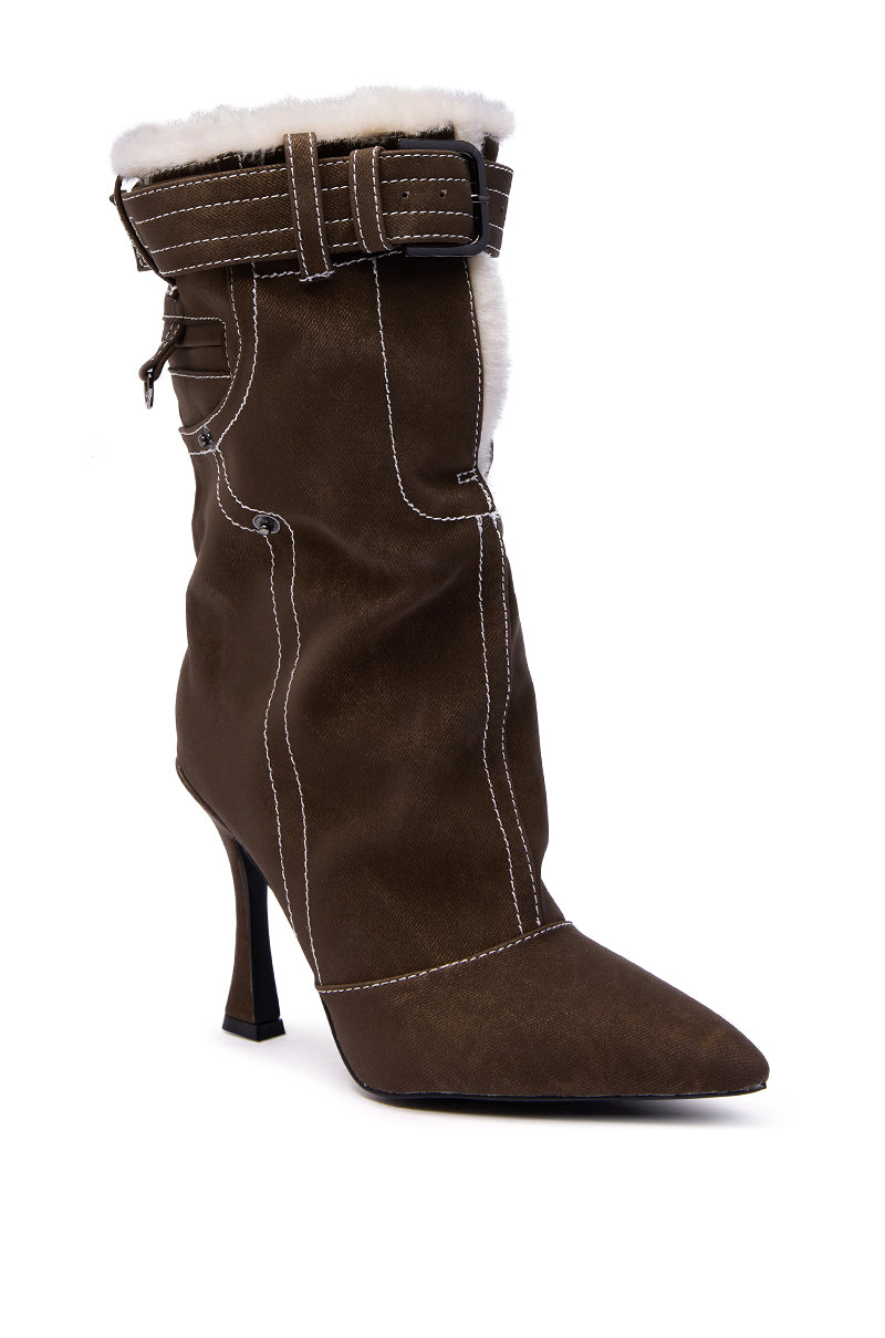 The AZALEA WANG TROYES BROWN SHERPA LINED PANT LOOK BOOTIE features ankle height, a stiletto heel, white faux fur lining, pointed toe, contrast stitching, and a decorative strap with buckle at the top.
