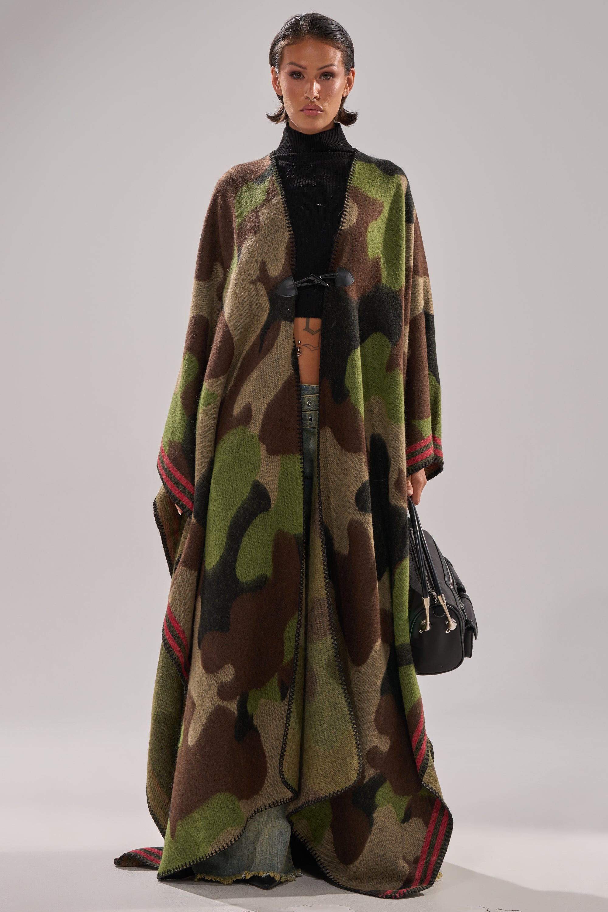 The CAMO NIGHTS MAXI PONCHO offers a cozy layer perfect for any season.