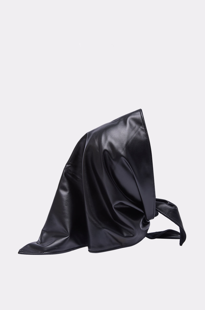 The ITS A WRAP PU HOOD features a shiny black pointed design with loose draping and back ties. Crafted from smooth, glossy PU, it adds an edgy vibe and is showcased against a plain light background. 3