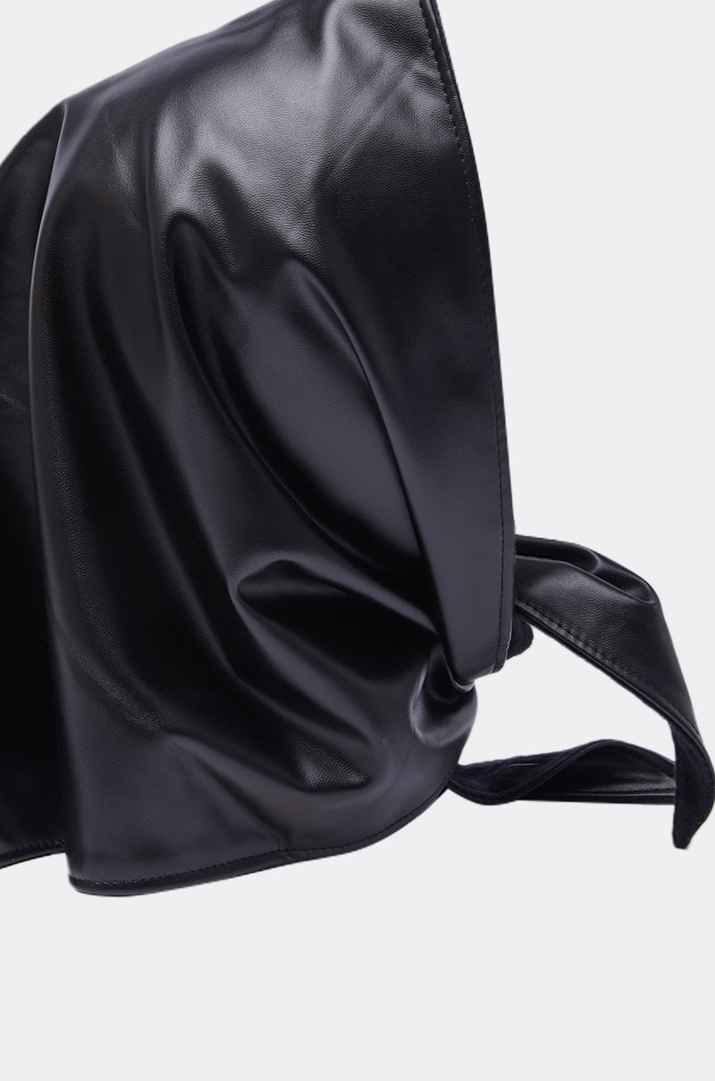 A shiny black faux leather bag with a twisted strap sits against a light background—perfect for pairing with your ITS A WRAP PU HOOD for a stylish, coordinated look. 4