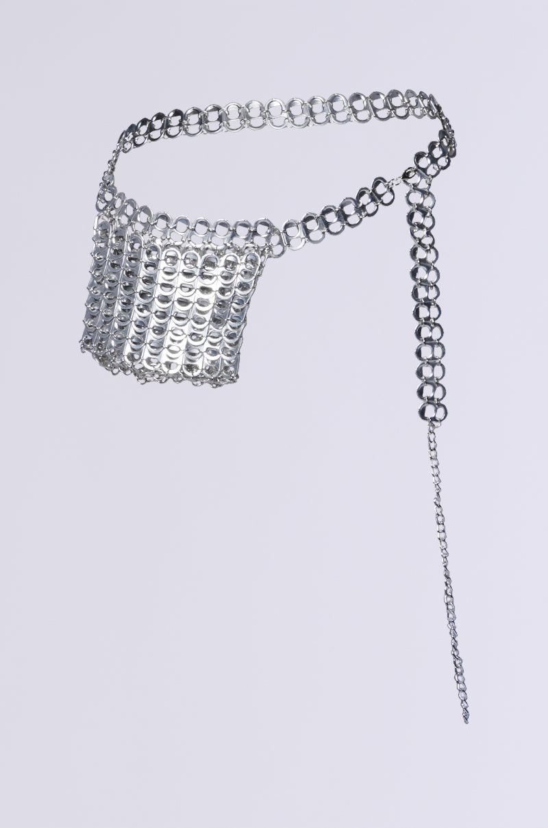 The WAYNE POP TAB BELT BAG showcases a shiny silver, chainmail-like design with large circular links and an adjustable chain on one side, all set against a plain background. 1