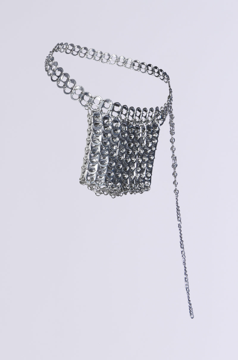 The WAYNE POP TAB BELT BAG is a metallic accessory crafted from shiny silver interlocking circular rings, forming a structured square panel with an adjustable chain on one end, set against a plain white background. 3