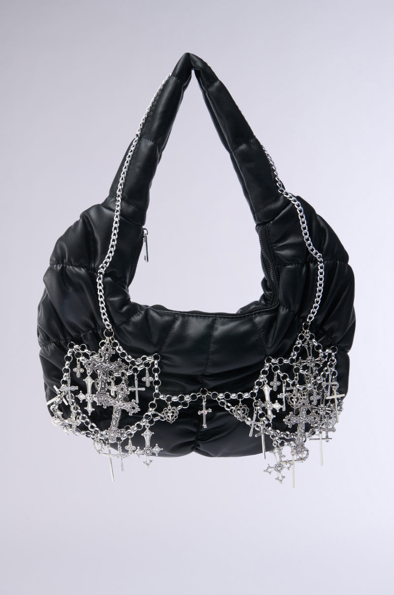 The TOO SPECIAL CROSS CHAIN PURSE is a black faux leather crescent-shaped bag featuring puffy design, gothic-inspired hardware, and intricate silver chains with multiple dangling cross charms, shown against a plain light gray background. 1