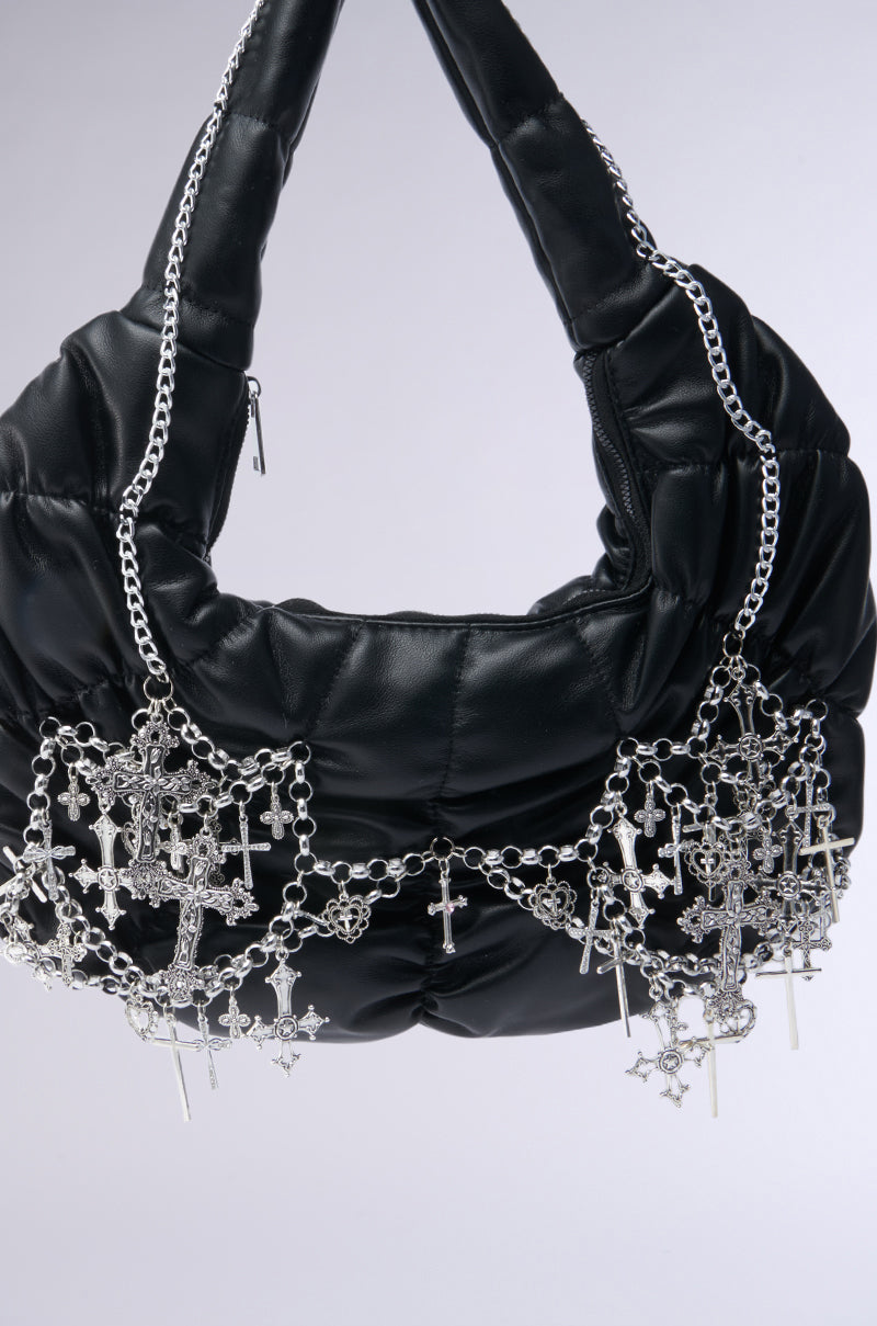 The TOO SPECIAL CROSS CHAIN PURSE is a black faux leather, quilted bag with gothic silver chain straps and dangling cross and star charms, shown against a plain light background. 4