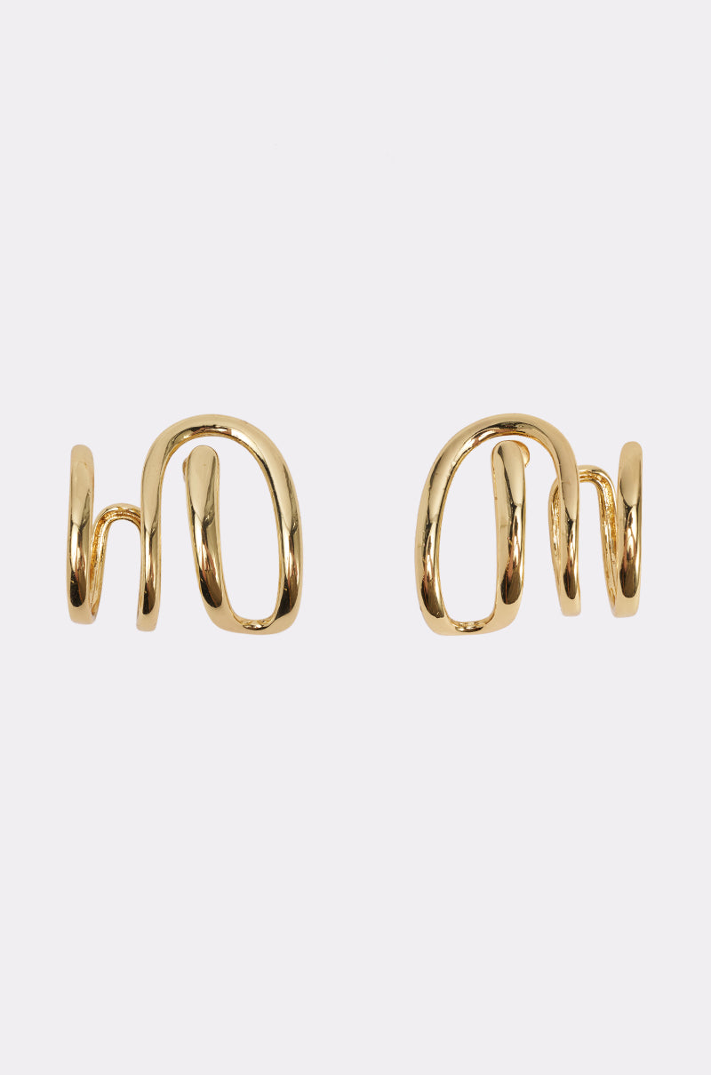 ART GALLERY EARRING: A pair of gold-tone ear cuffs featuring an abstract, wavy open design, perfect as elegant wedding guest accessories and displayed on a plain white background.