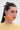 A woman with long brown hair in a half-up style wears the FRESH START FLOWER EARRING—large, orange, flower-shaped acrylic earrings—with a pale yellow textured top against a light background, creating the ideal spring look.