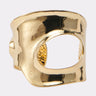 The MORE POWER TO YOU CUFF is a wide, faux gold metallic cuff by AKIRA Label, featuring an irregular, organic shape with a large asymmetrical cutout in the center, shown against a plain white background.