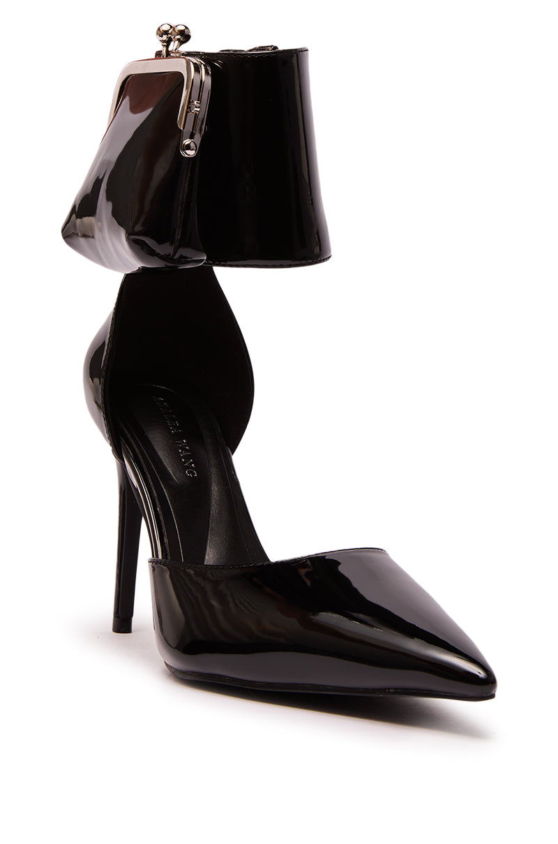 The AZALEA WANG TZIVA BLACK COIN PURSE PUMP features a black faux patent leather stiletto heel with a pointed toe, anklet strap, and a small attached coin purse for bold modern style.