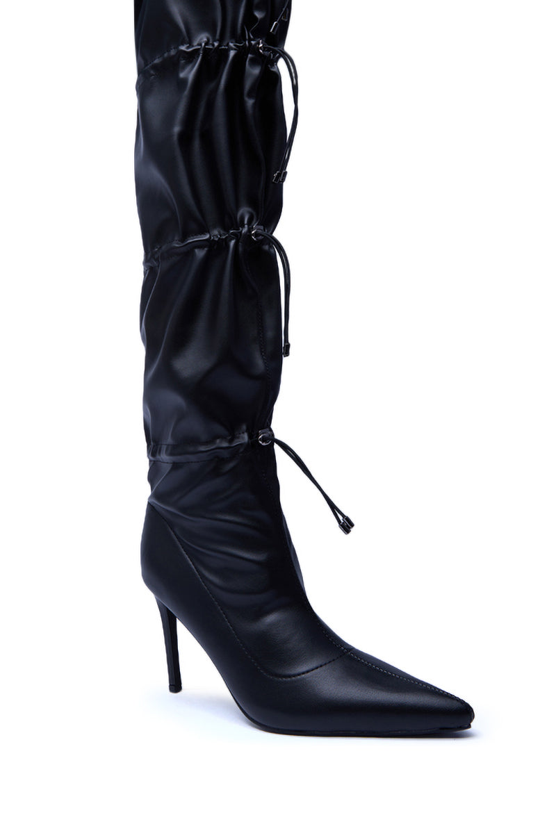 The AZALEA WANG ULVI Black Cinched Stiletto Boot features a pointed toe, high heel, gathered ruched shaft, and multiple adjustable drawstring ties, shown on a white background.