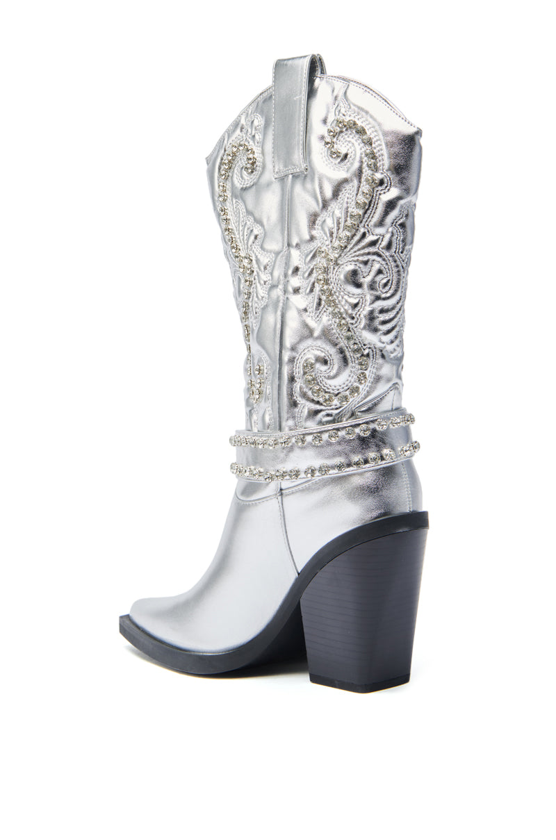 The AZALEA WANG UMBRA SILVER WESTERN BOOT features a high heel, baroque embroidery, decorative beading, a pull tab, and is crafted from metallic faux leather, shown in profile against a white background.