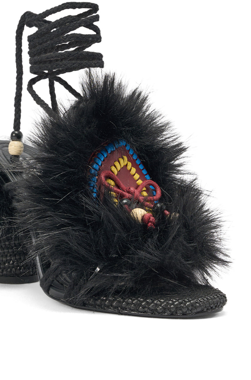 The AKIRA GOLD UMIKA BLACK FUR BLOCK SANDAL features a black faux fur trim, textured sole, colorful embroidery, and stylish lace-up straps adorned with small beads. 5