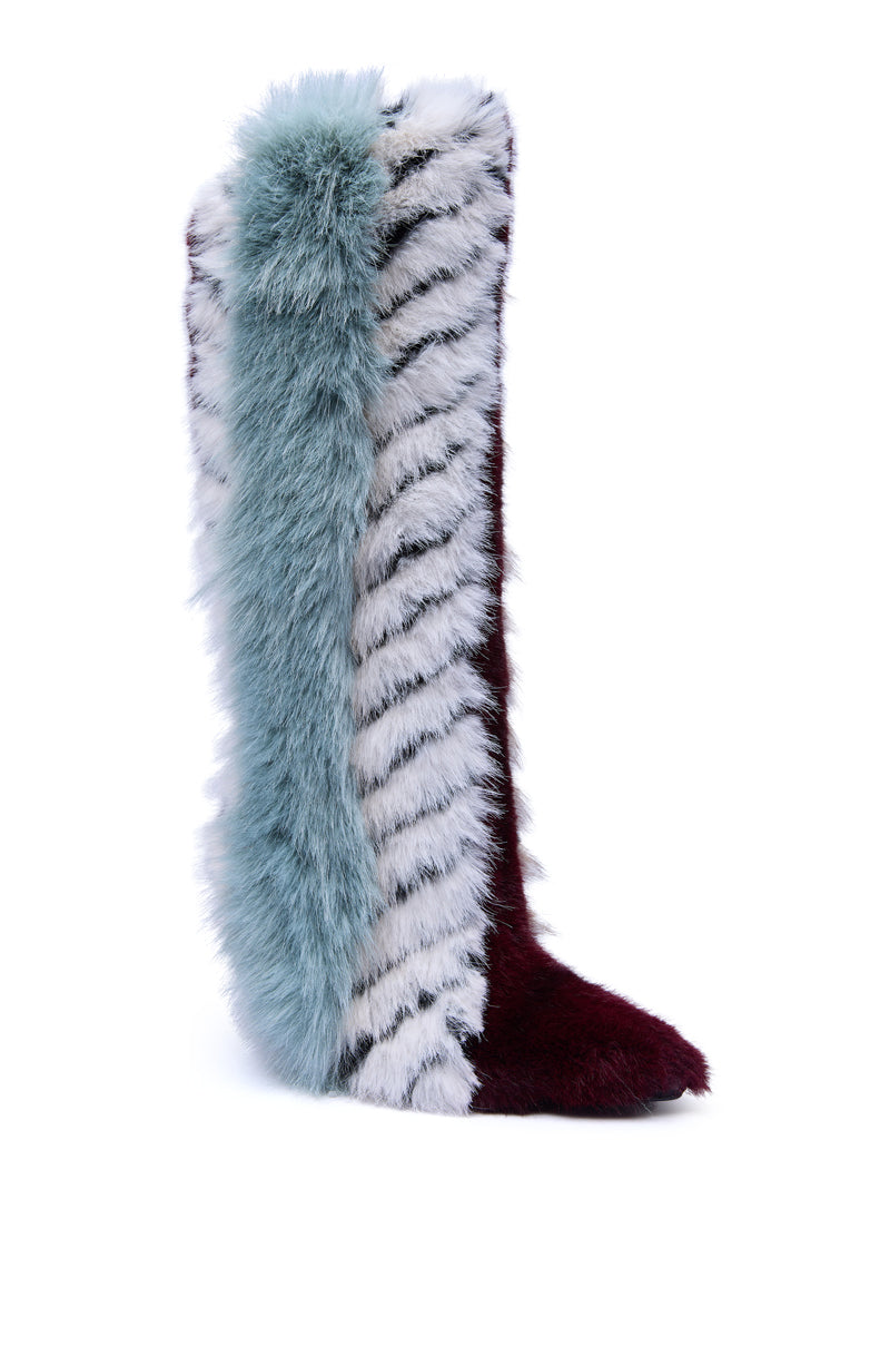 The AZALEA WANG UPSELLA BLUE MULTI STILETTO BOOT is a striking knee-high faux fur boot featuring bold burgundy, sky blue, and white colors with black zebra-like stripes for an eye-catching multi-color look.