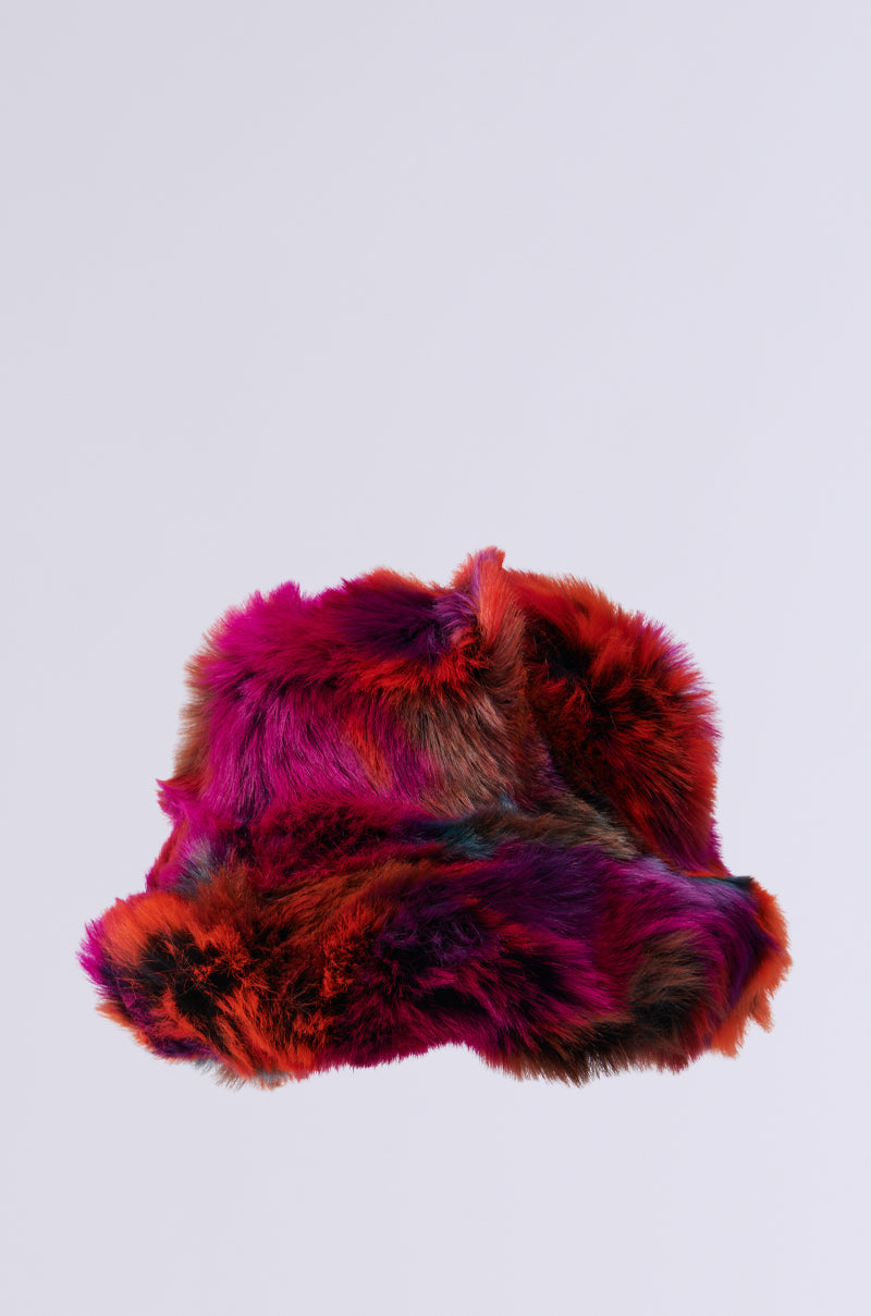 The UPSETTER FAUX FUR BUCKET HAT is a lively multicolored accessory that showcases vibrant shades of red, pink, purple, and blue set against a light gray background. Its oversized floppy design and fluffy texture lend it a playful and cozy look. 2