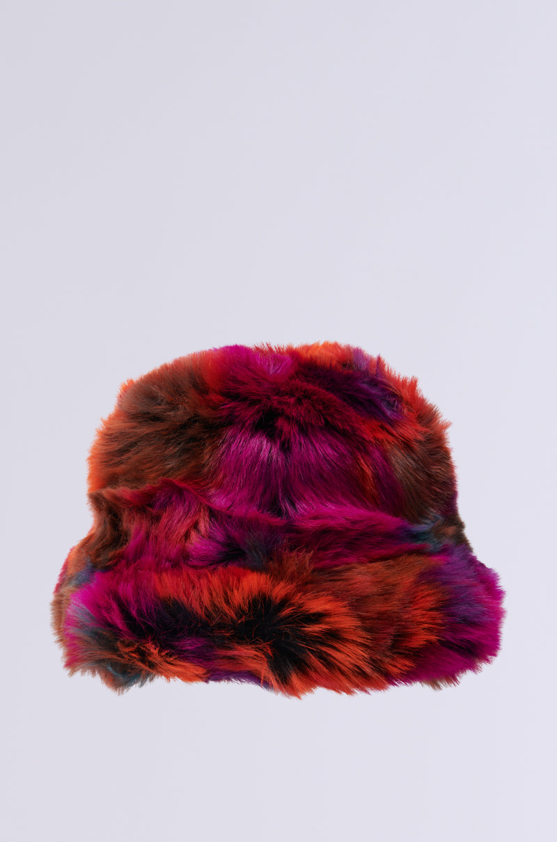 The UPSETTER FAUX FUR BUCKET HAT features a dynamic mix of red, purple, and black against a light gray background. Its plush texture and large, floppy shape make it both fashionable and attention-grabbing. 3