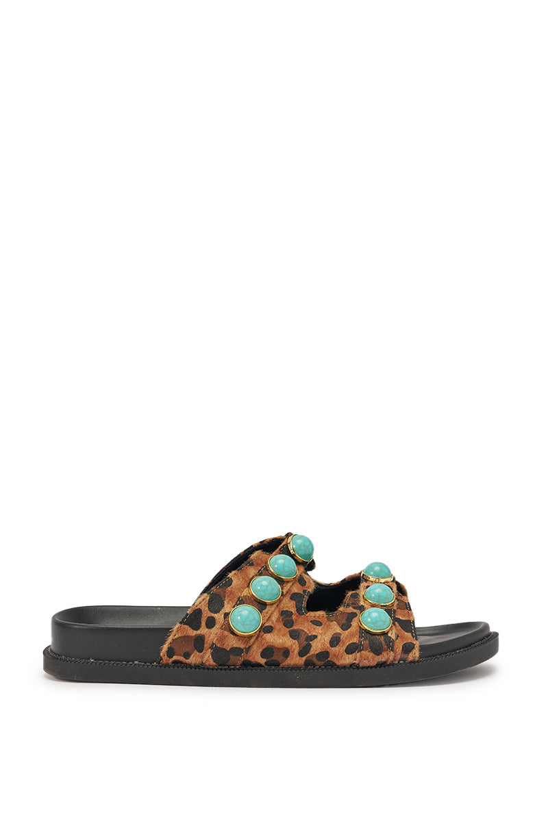 The AZALEA WANG UZUMATI LEOPARD SLIP ON SANDAL WITH STONES features a calf-hair leopard print, a black sole, and a brown and black strap decorated with vibrant turquoise stone accents. 4