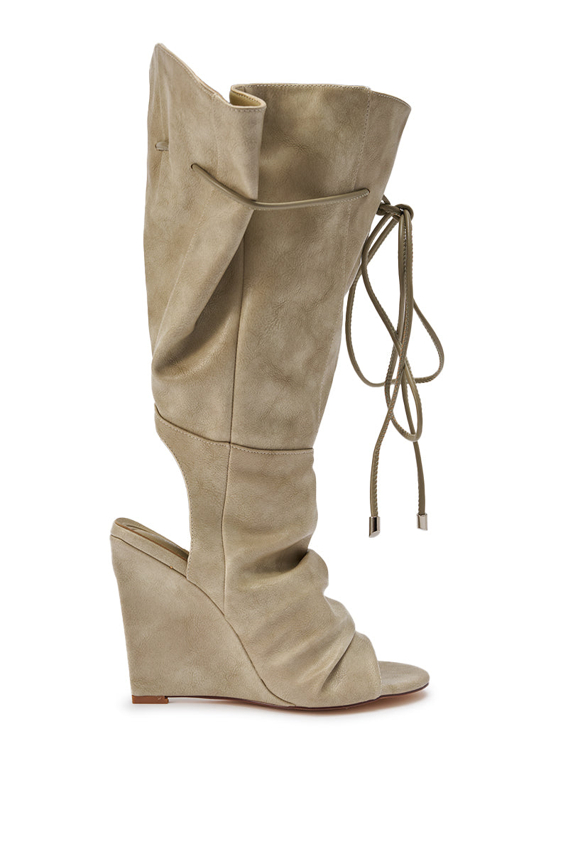 The AZALEA WANG VAILEN GREY OPEN TOE SLOUCHY BOOTIE features taupe suede, a wedge heel, scrunched shaft, exposed heel, and decorative side ties, displayed against a plain white background. 8