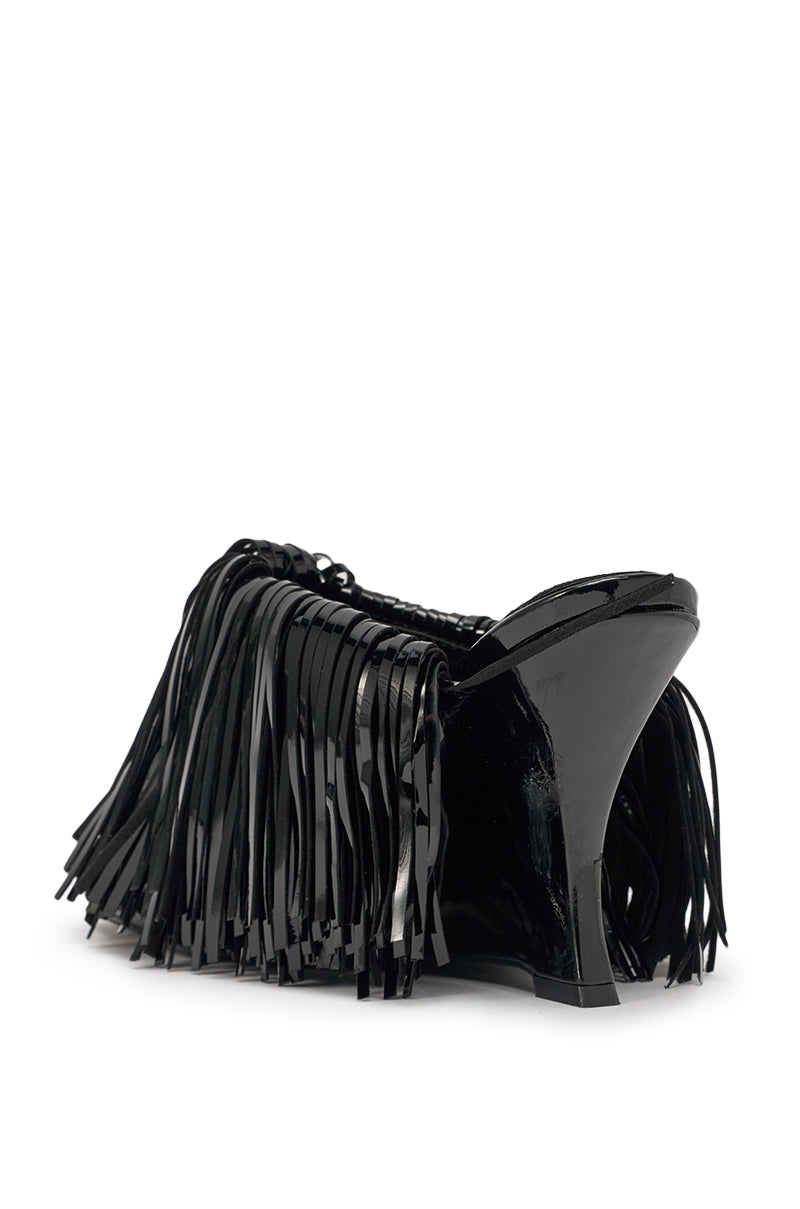 The AZALEA WANG VAILYN BLACK FRINGE PU WEDGE SANDAL is a stylish black faux leather sandal with glossy fringe details and a chic wedge heel, shown from the back at a slight angle on a white background. 7