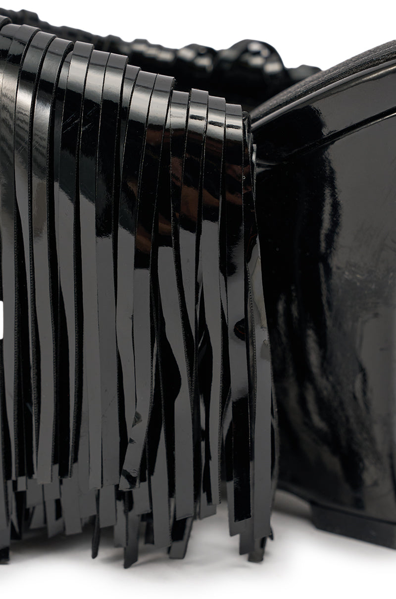 Close-up of the AZALEA WANG VAILYN BLACK FRINGE PU WEDGE SANDAL, showing glossy black PU leather with fringe details that reflect light and highlight the sleek, stylish texture. 8