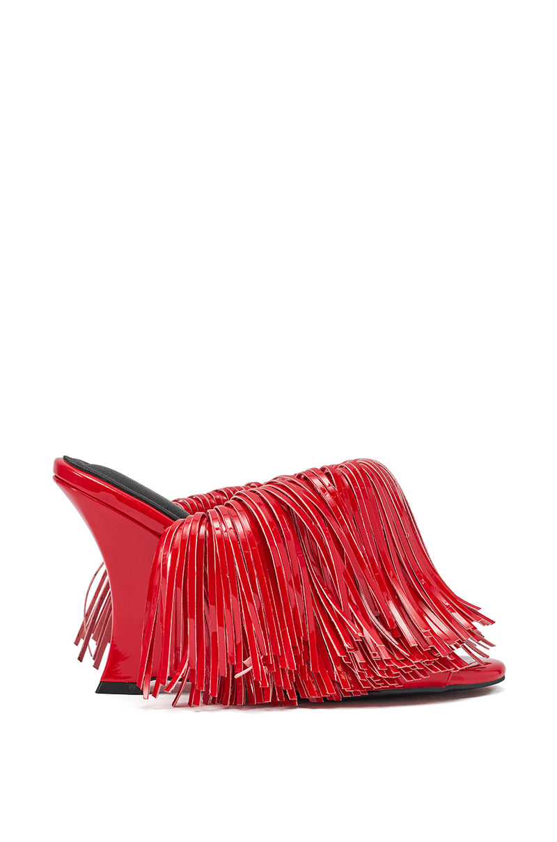 The AZALEA WANG VAILYN RED FRINGE PU WEDGE SANDAL is a cherry red mule with a glossy faux patent leather finish, long layered fringe details on the upper and sides, and features a stylish wedge heel. 3
