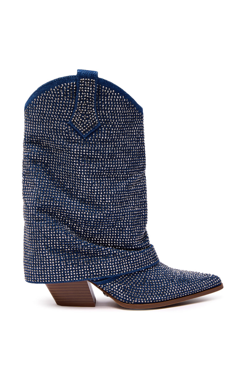The AZALEA WANG VANADIS DENIM RHINESTONE COWBOY BOOTIE features a side view of blue denim with rhinestones and small silver studs, a slouchy shaft, and a low, angled wooden heel.