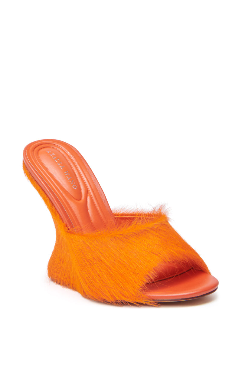 The AZALEA WANG VASA ORANGE FURRY WEDGE SANDAL features faux pony hair on the upper and sides, an open almond toe, and a leather insole. 5
