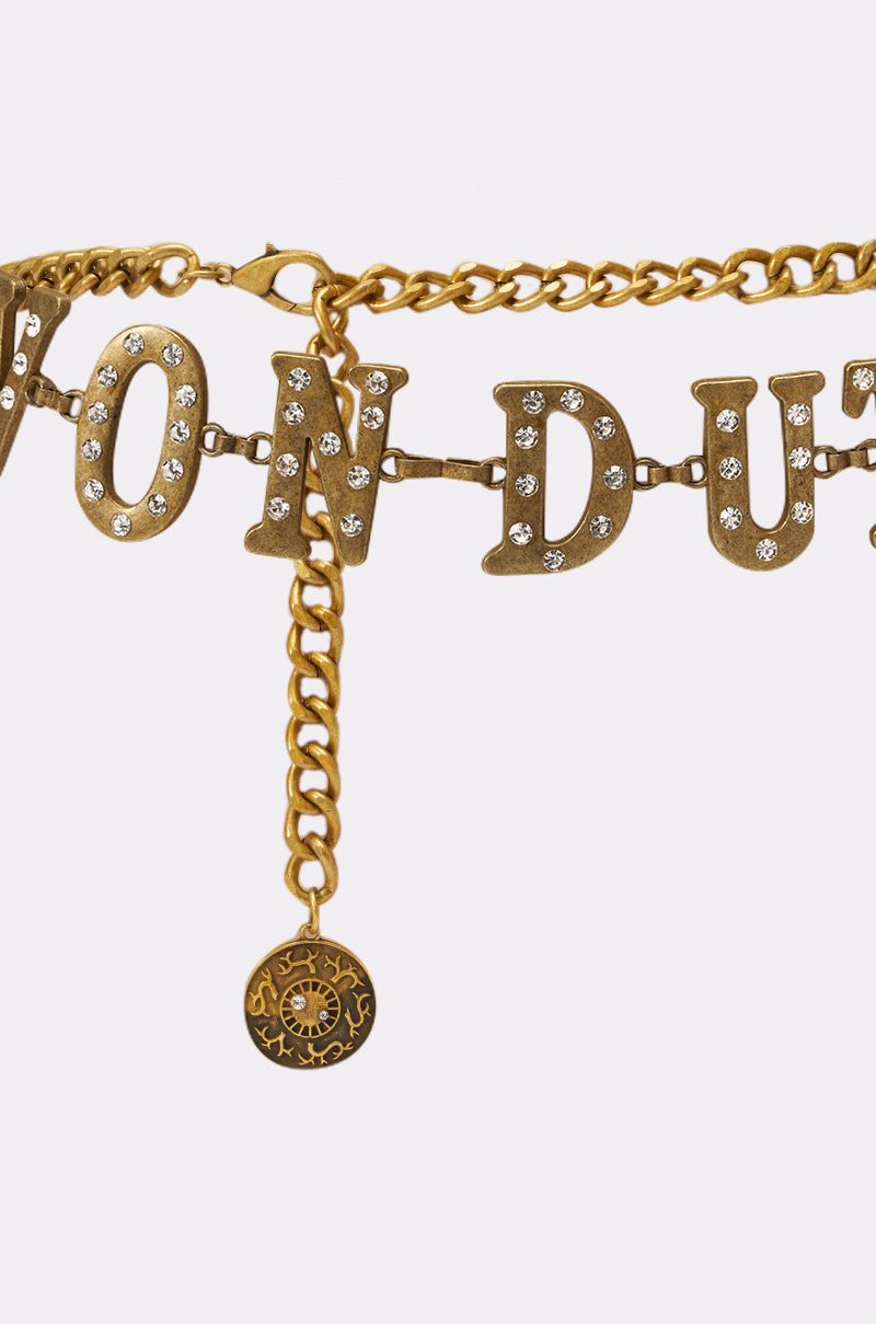 The VON DUTCH RHINESTONE CHAIN BELT is a gold chain necklace with large, rhinestone-studded "VON DUTCH" letters and a dangling sun charm. 2
