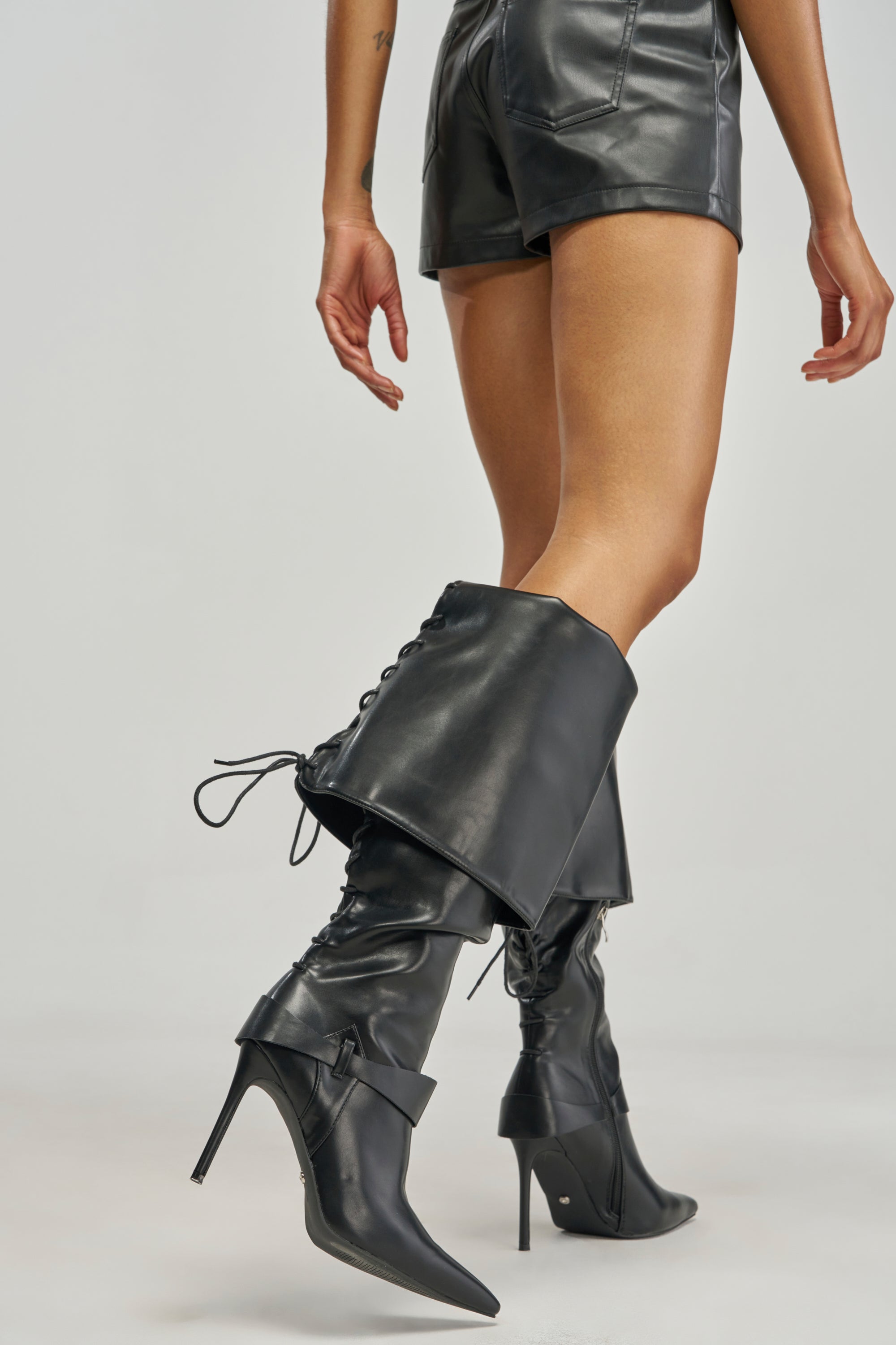 AZALEA WANG VELA BLACK PU KNEE HIGH STILETTO BOOTS featuring a folded cuff detail and back lacing.